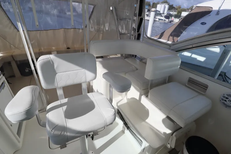  Yacht Photos Pics 2006 Rampage 33 Express boat interior with white seating and helm station.