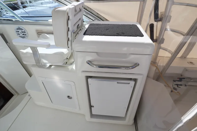  Yacht Photos Pics 2006 Rampage 33 Express boat interior with white seating and storage compartments.