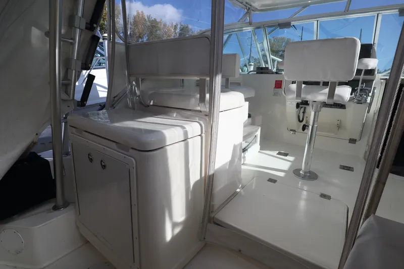  Yacht Photos Pics 2006 Rampage 33 Express boat interior with white seating and helm station.