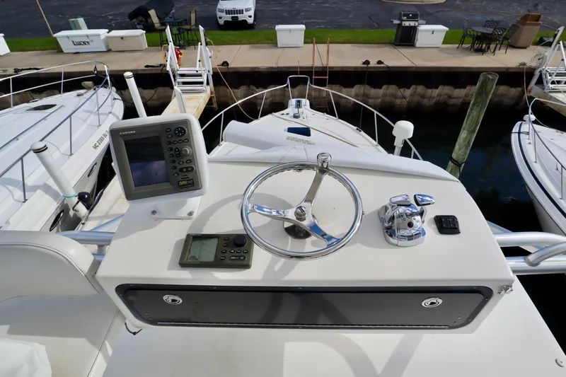  Yacht Photos Pics 2006 Rampage 33 Express boat helm with navigation equipment and steering wheel.