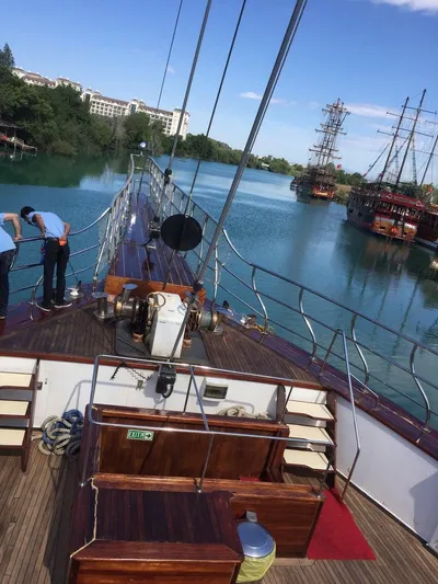 My Dream Yacht Photos Pics 2009 Custom Manavgat GT 457 yacht on a serene river with crew members.