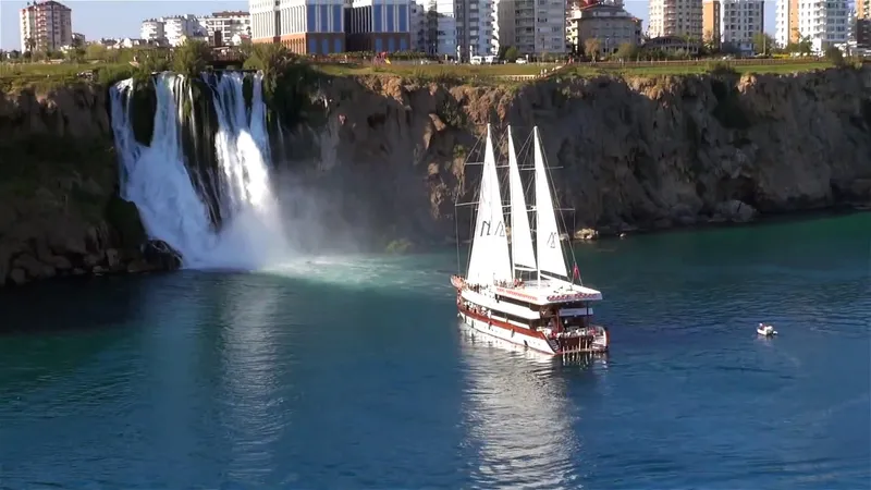 My Dream Yacht Photos Pics Sailing ship Manavgat GT 457 near a waterfall and coastal cityscape, 2009.