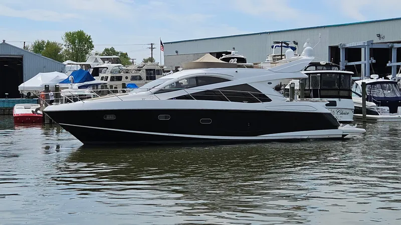 Far Niente Yacht Photos Pics 2012 Sunseeker Manhattan 53 yacht docked at marina, surrounded by other boats.