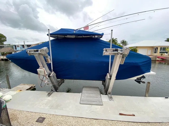  Yacht Photos Pics 2015 Intrepid 327i Open boat covered and docked on a lift.