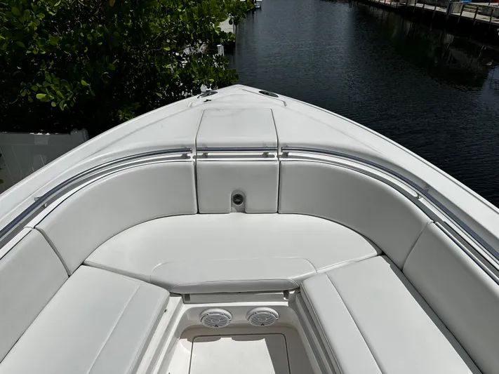  Yacht Photos Pics 2015 Intrepid 327i Open boat bow seating area with white cushions.
