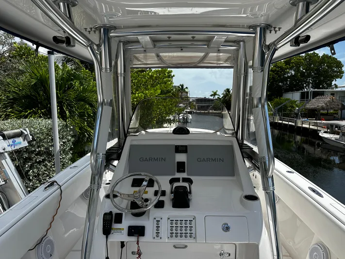  Yacht Photos Pics 2015 Intrepid 327i Open boat cockpit with Garmin navigation system and steering wheel.