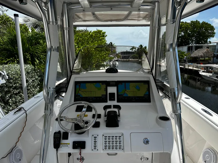  Yacht Photos Pics 2015 Intrepid 327i Open boat cockpit with navigation system and steering wheel.