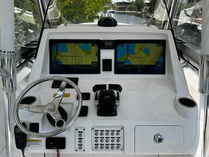  Yacht Photos Pics 2015 Intrepid 327i Open boat helm with dual navigation screens and steering wheel.