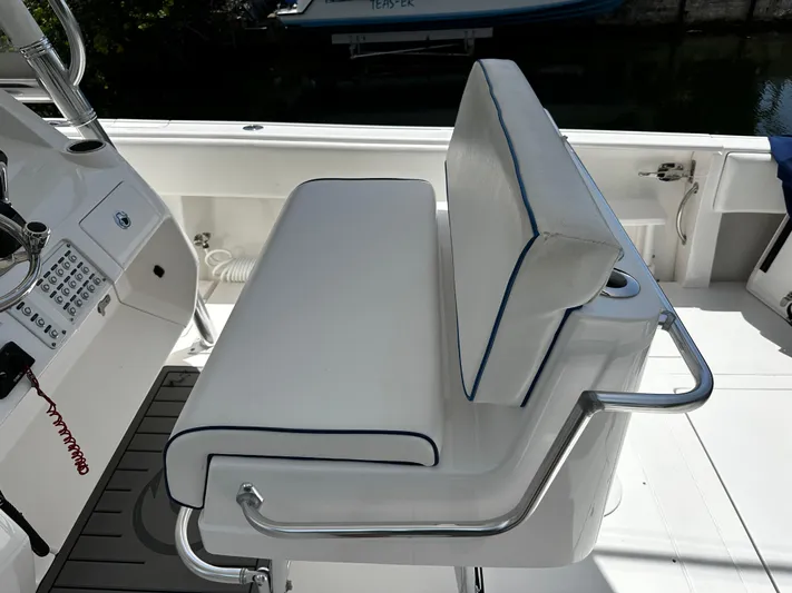  Yacht Photos Pics 2015 Intrepid 327i Open boat with white cushioned seating and control panel.