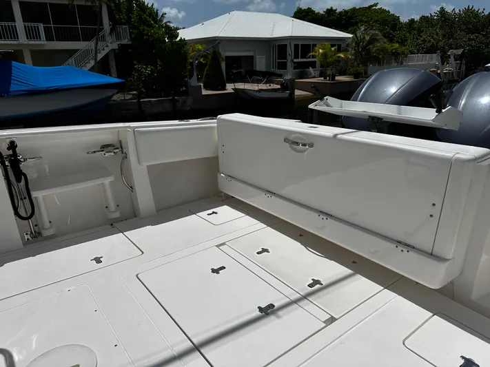  Yacht Photos Pics 2015 Intrepid 327i Open boat deck with storage compartments and dual outboard motors.