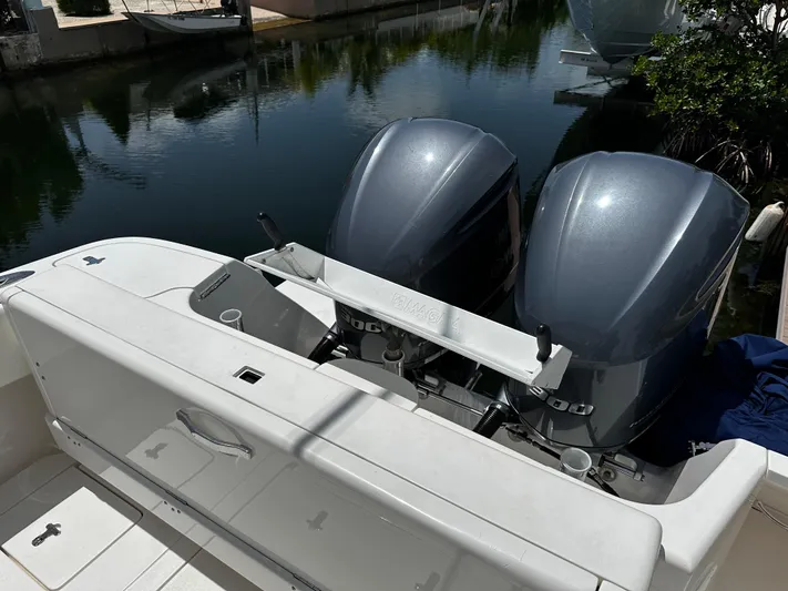  Yacht Photos Pics 2015 Intrepid 327i Open boat with twin outboard engines docked by the water.