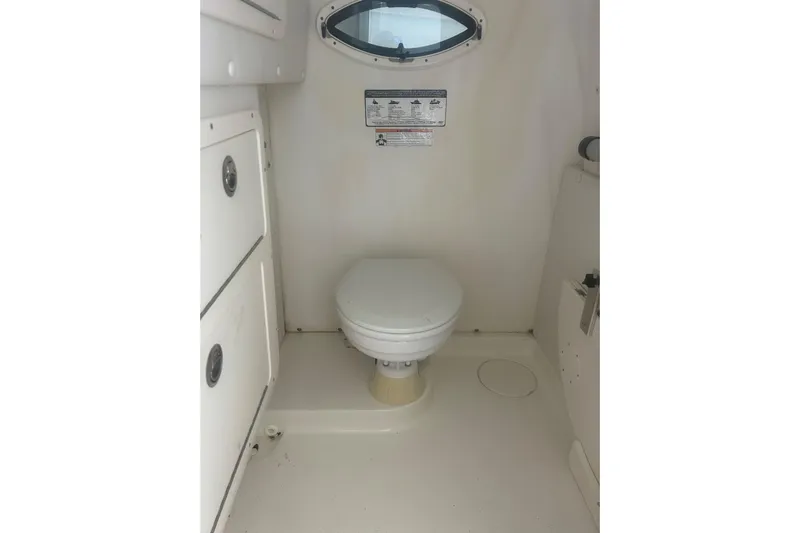  Yacht Photos Pics 2018 World Cat 320 CC boat interior with compact marine toilet.