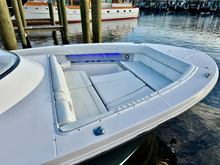  Yacht Photos Pics 2021 Regal 38 SAV boat with spacious white seating area docked at marina.