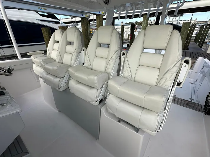  Yacht Photos Pics Luxurious seating on 2021 Regal 38 SAV boat, featuring plush white leather chairs.