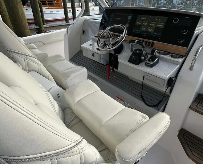  Yacht Photos Pics 2021 Regal 38 SAV boat cockpit with modern controls and plush seating.