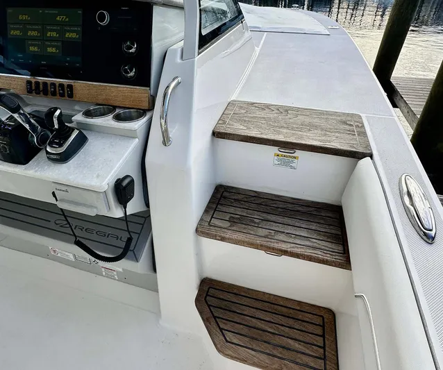  Yacht Photos Pics 2021 Regal 38 SAV boat interior with wooden steps and control panel.