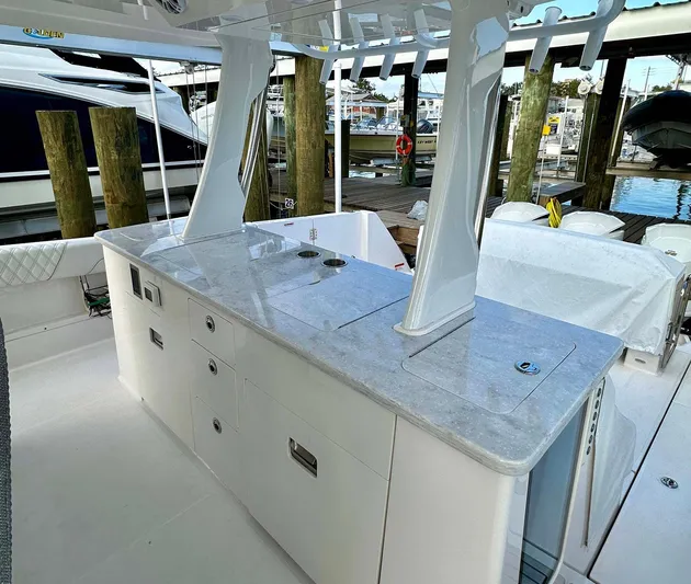  Yacht Photos Pics 2021 Regal 38 SAV yacht with sleek outdoor kitchen and marina backdrop.