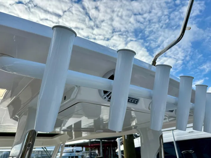  Yacht Photos Pics 2021 Regal 38 SAV boat rod holders under a blue sky.