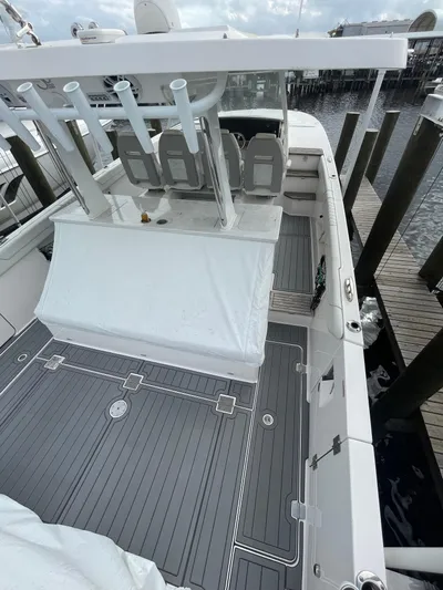  Yacht Photos Pics 2021 Regal 38 SAV boat docked, featuring spacious deck and modern design.