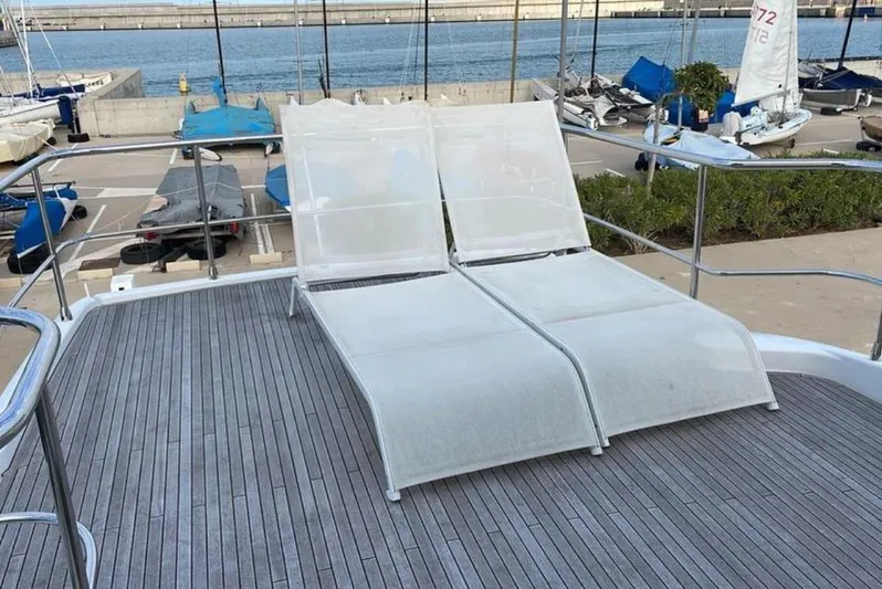  Yacht Photos Pics Sun loungers on Azimut Magellano 66 yacht deck, 2019 model, docked at marina.