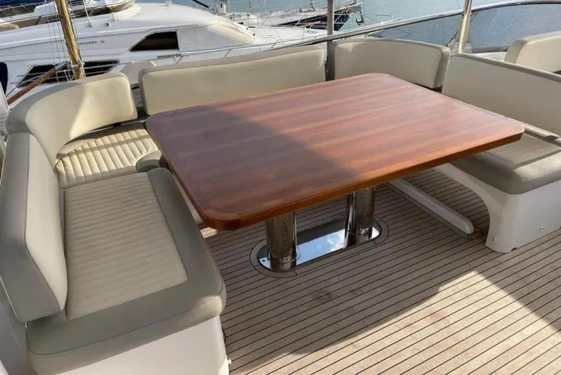  Yacht Photos Pics Luxurious seating area on 2019 Azimut Magellano 66 yacht with wooden table.