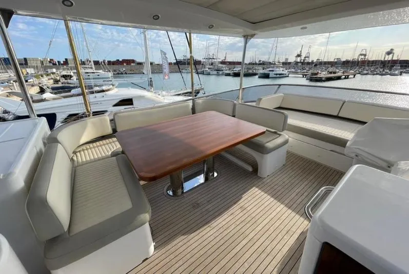  Yacht Photos Pics Outdoor seating area on a 2019 Azimut Magellano 66 yacht, docked at a marina.