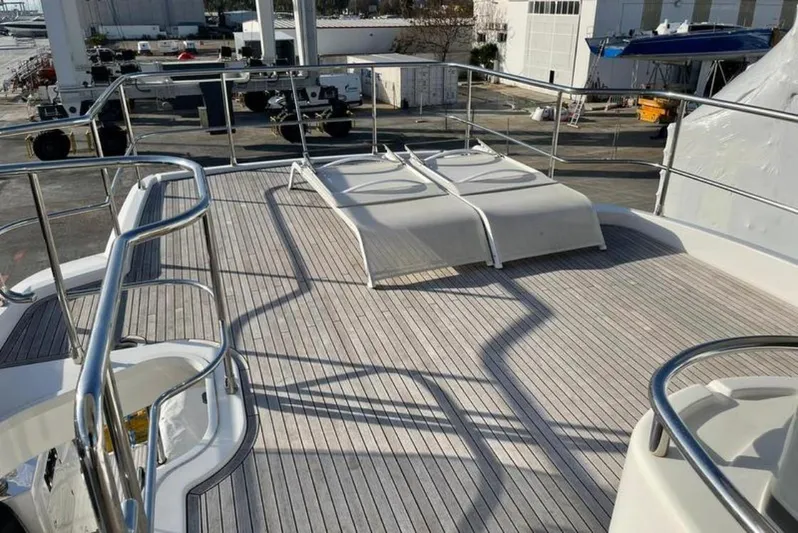  Yacht Photos Pics Sun deck of 2019 Azimut Magellano 66 yacht with lounge chairs and railing.