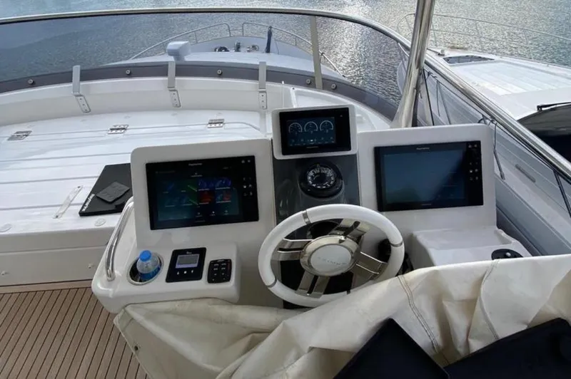  Yacht Photos Pics Cockpit of 2019 Azimut Magellano 66 yacht with modern navigation displays and steering wheel.