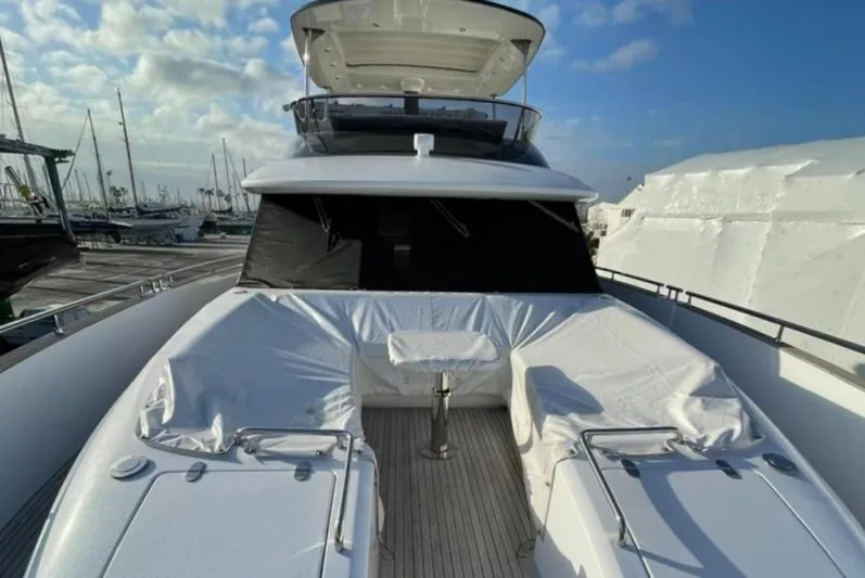  Yacht Photos Pics Azimut Magellano 66 yacht, 2019 model, docked with covered seating area under a clear sky.