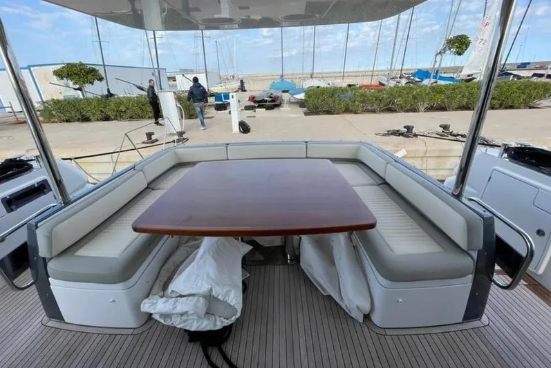  Yacht Photos Pics Azimut Magellano 66 yacht's outdoor seating area with a wooden table, 2019 model.