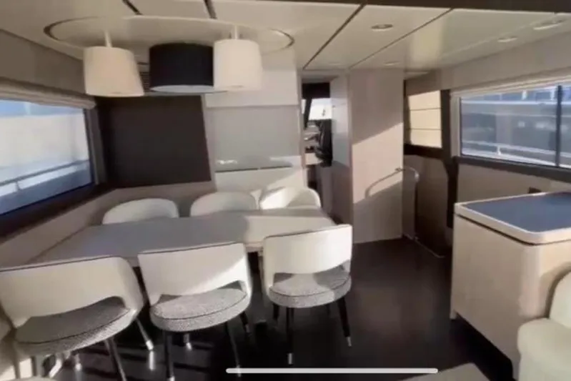  Yacht Photos Pics Interior of 2019 Azimut Magellano 66 yacht with modern dining area and large windows.