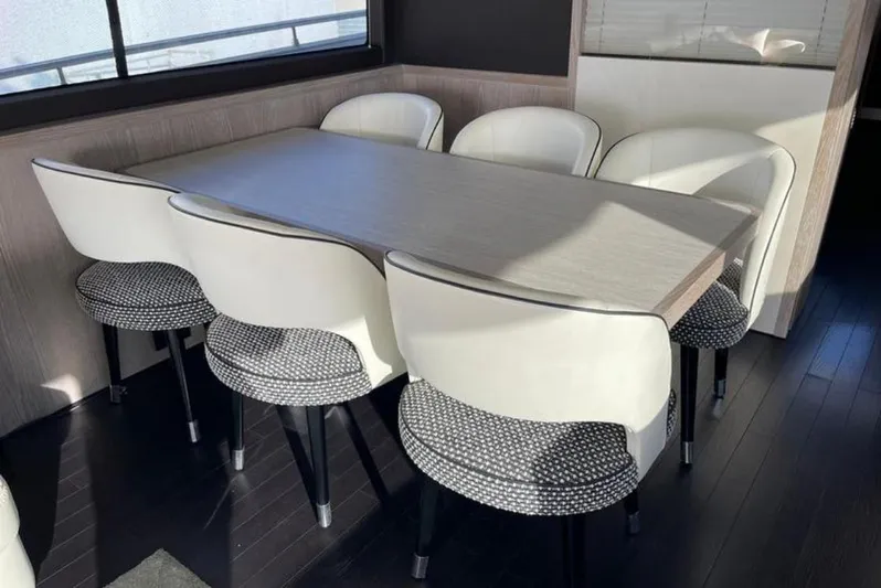  Yacht Photos Pics Dining area on 2019 Azimut Magellano 66 yacht with modern table and chairs.