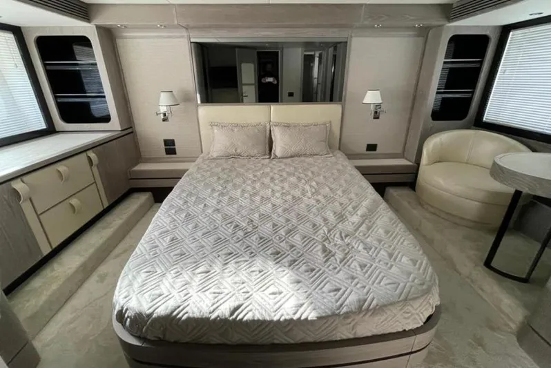 Yacht Photos Pics Luxurious bedroom interior of 2019 Azimut Magellano 66 yacht with elegant bedding and modern decor.