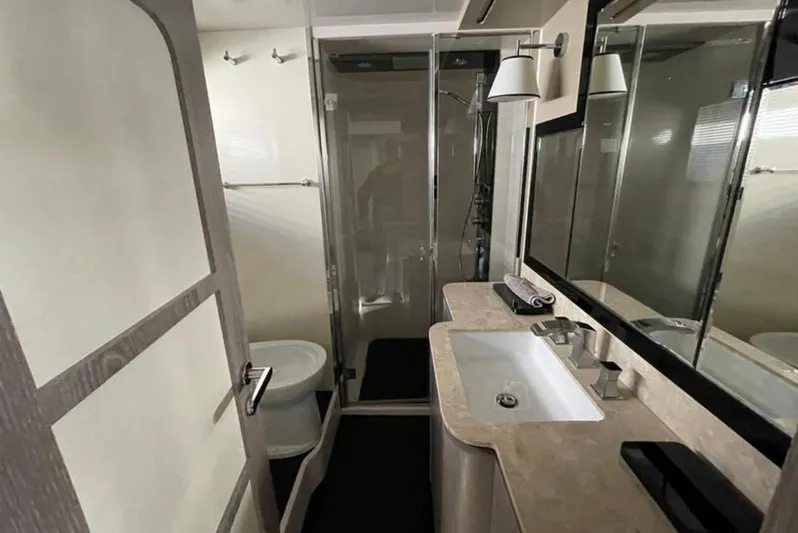  Yacht Photos Pics Luxurious bathroom in 2019 Azimut Magellano 66 yacht with modern fixtures and glass shower.