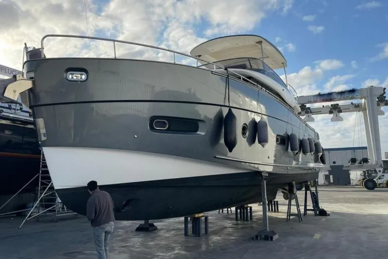  Yacht Photos Pics 2019 Azimut Magellano 66 yacht on dry dock under a cloudy sky.