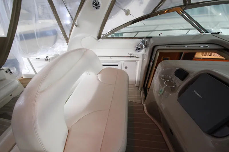  Yacht Photos Pics Interior of 2000 Sea Ray 410 Sundancer yacht with white seating and control panel.
