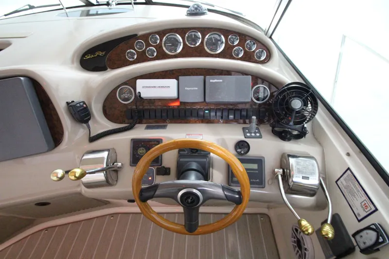  Yacht Photos Pics Control panel of a 2000 Sea Ray 410 Sundancer boat with steering wheel and gauges.