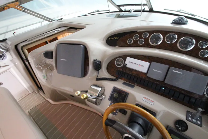  Yacht Photos Pics Helm of 2000 Sea Ray 410 Sundancer with navigation instruments and wood-accented steering wheel.