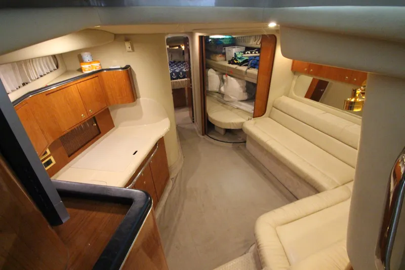  Yacht Photos Pics Luxurious interior of 2000 Sea Ray 410 Sundancer yacht with elegant seating and cabinetry.