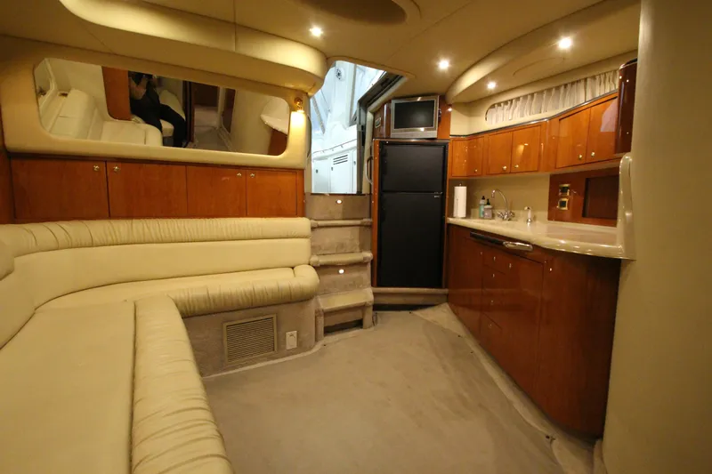  Yacht Photos Pics Luxurious interior of a 2000 Sea Ray 410 Sundancer yacht with plush seating and kitchenette.
