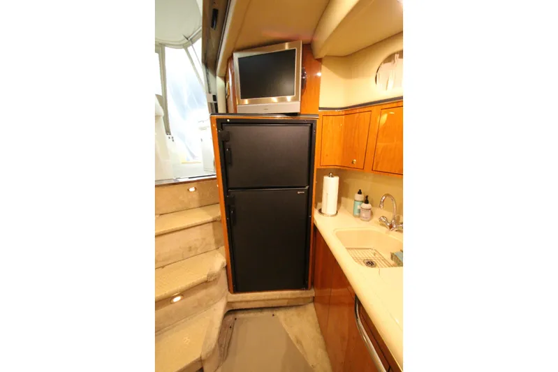  Yacht Photos Pics 2000 Sea Ray 410 Sundancer yacht interior with kitchenette, fridge, and stairs.
