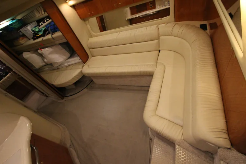  Yacht Photos Pics Interior of 2000 Sea Ray 410 Sundancer yacht with beige leather seating and wooden accents.