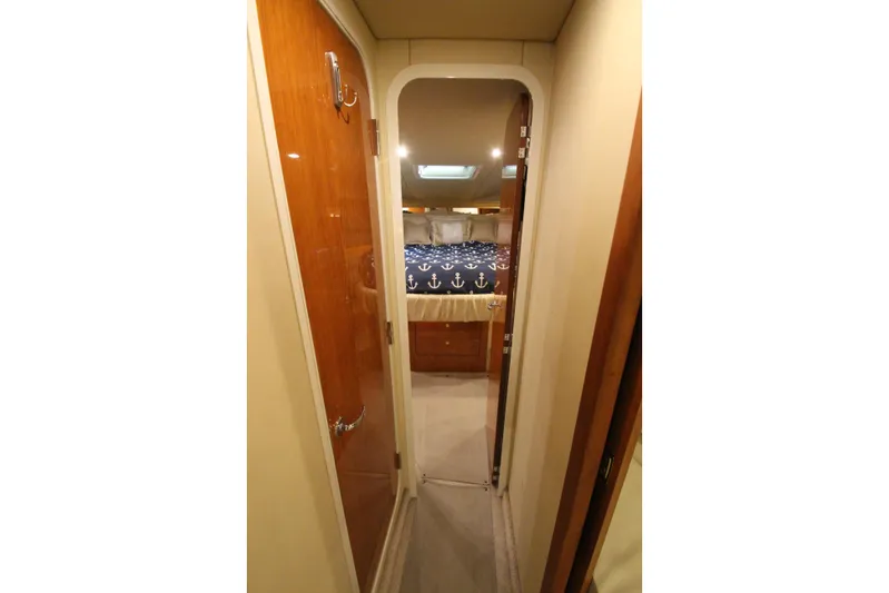  Yacht Photos Pics Interior hallway of 2000 Sea Ray 410 Sundancer yacht, leading to a cozy bedroom.