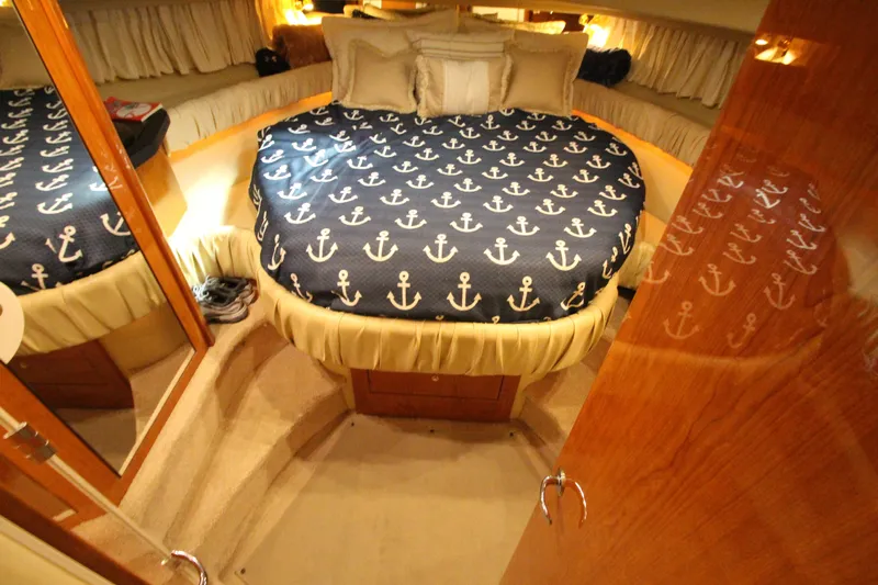  Yacht Photos Pics Luxurious cabin interior of 2000 Sea Ray 410 Sundancer yacht with anchor-themed bedding.