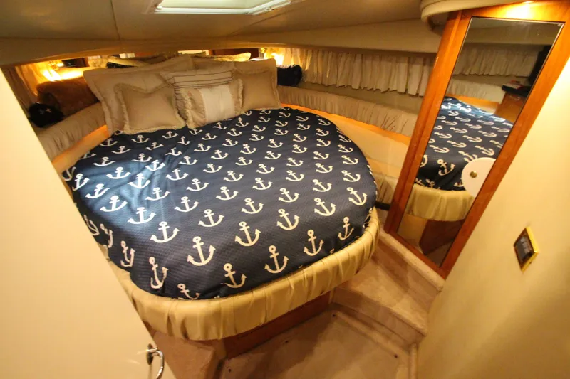  Yacht Photos Pics Luxurious cabin interior of 2000 Sea Ray 410 Sundancer with nautical-themed bedding.