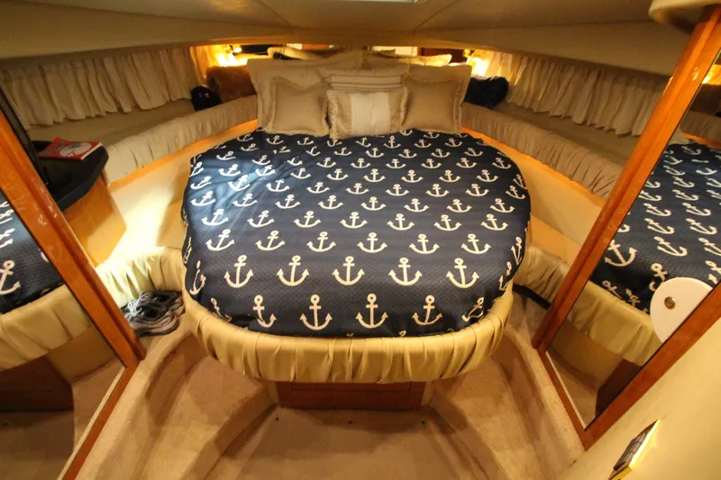  Yacht Photos Pics Luxurious cabin interior of 2000 Sea Ray 410 Sundancer with anchor-themed bedding.