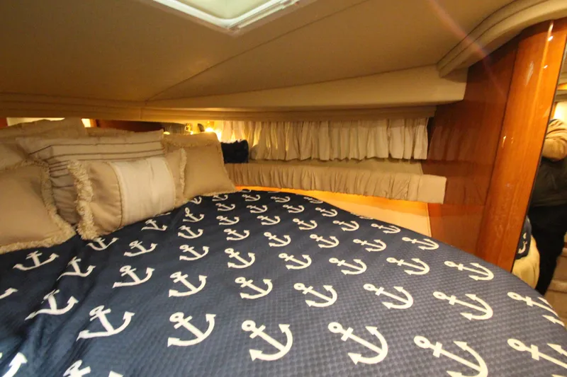  Yacht Photos Pics Cozy cabin interior of 2000 Sea Ray 410 Sundancer with anchor-themed bedding.