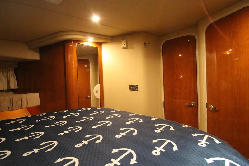  Yacht Photos Pics Interior cabin of 2000 Sea Ray 410 Sundancer with anchor-patterned bedding.