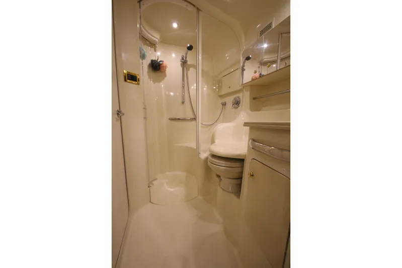  Yacht Photos Pics 2000 Sea Ray 410 Sundancer bathroom with shower, toilet, and mirrored cabinet.