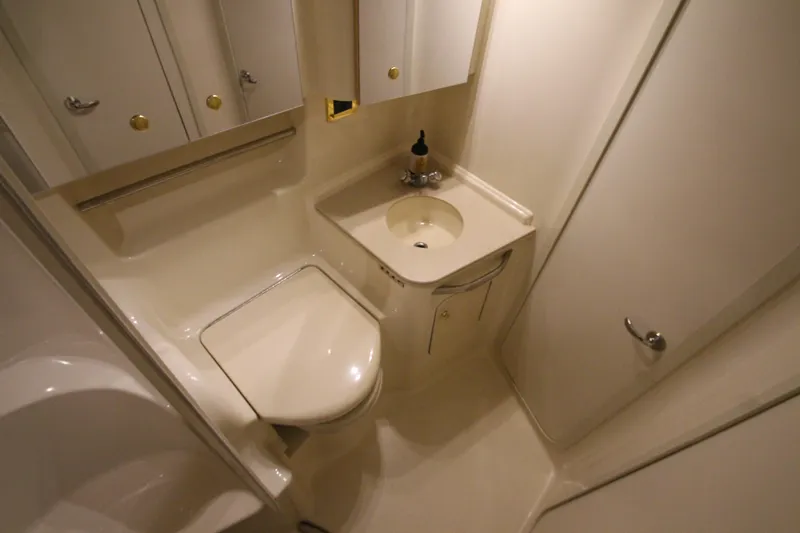  Yacht Photos Pics Compact bathroom in 2000 Sea Ray 410 Sundancer yacht, featuring sink and toilet.